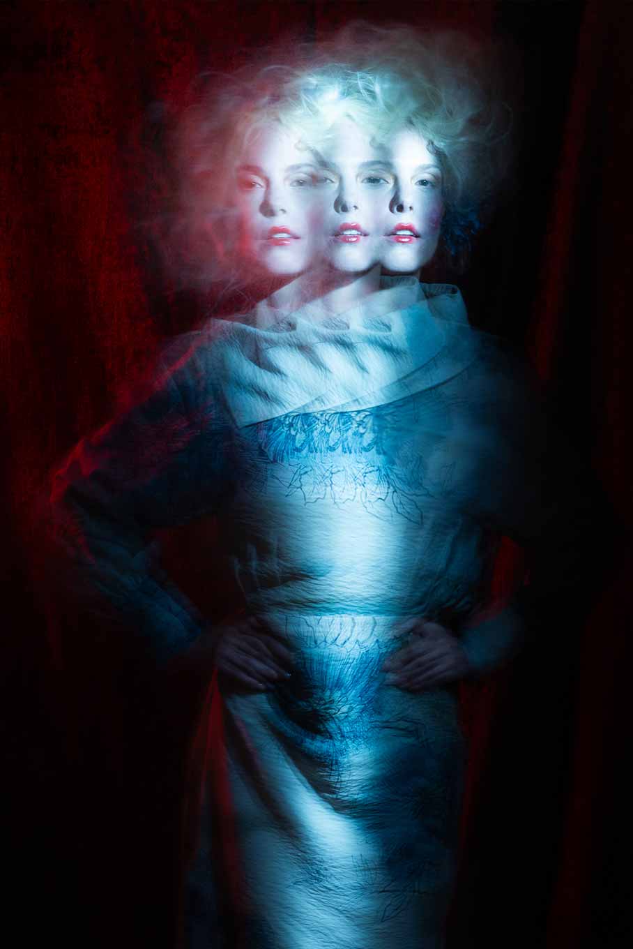 American shot portrait of a model with three overlapping exposures, creating a mysterious, dreamlike effect with blurred and multiplied forms.
